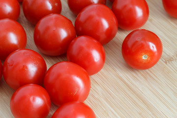 the harvest of ripe tomatoes is on the wooden kitchen table