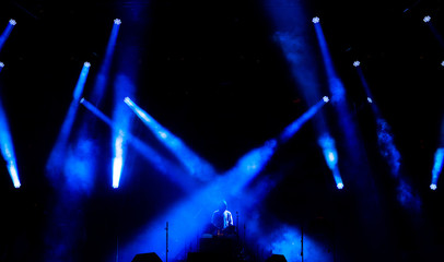 Beautiful concert light on an empty stage in the smoke. Disco and laser show.