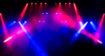 Beautiful concert light on an empty stage in the smoke. Disco and laser show.