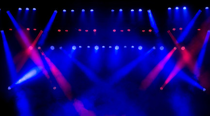Beautiful concert light on an empty stage in the smoke. Disco and laser show.