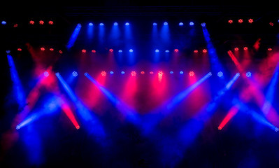 Fototapeta na wymiar Beautiful concert light on an empty stage in the smoke. Disco and laser show.
