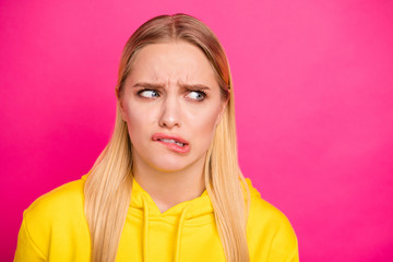 Photo of pretty lady looking with fear empty space wear yellow hoodie pullover isolated pink...