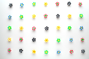 Multicolored decorative flowers on a white table