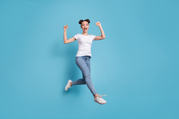 Fototapeta na wymiar Full body photo of jumping lady came fihish race first wear white casual t-shirt jeans denim isolated blue background