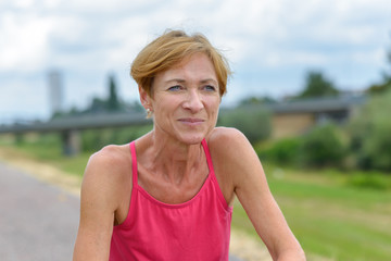 Athletic woman squatting to rest after a workout