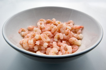 Boiled shrimps in white bowl, isolated on white background