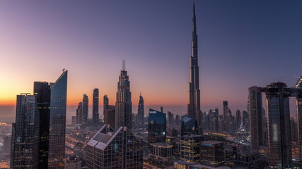 Fototapeta premium Dubai downtown skyline with tallest skyscrapers and busiest traffic on highway intersection night to day timelapse