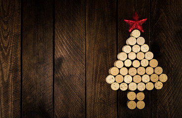 Christmas tree made of wine corks on wooden background. Mockup postcard with Christmas tree and...