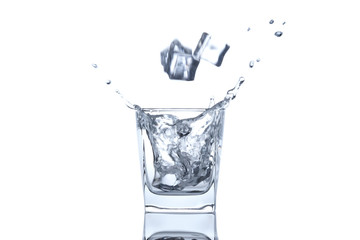 The ice cube splash into glass of water