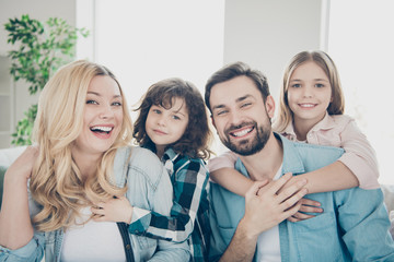Photo of four family members after adoption having best time togetherness sit couch indoors...