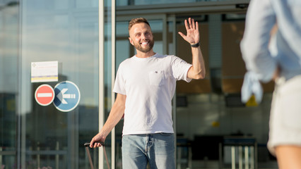 Arriving at airport. Young man greeting girlfriend