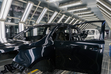 Close-up of the car body after painting at the car factory. Machine Assembly production