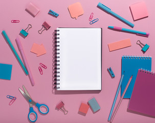 Notepad with blank space surrounded by creative office supplies