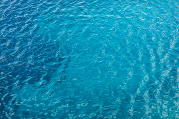 Blue sea surface with transparent shallow water
