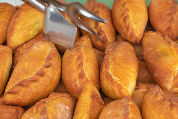 Traditional tasty Russian pies on the counter in the store.