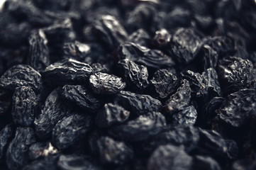 Macro photo of tasty organic black raisins.