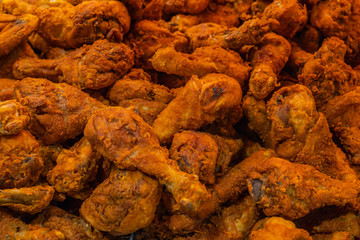 Pile of crispy and tasty fried chicken drumsticks for background