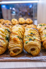Closeup photo of freshly baked puff pastry rolls in bakeshop