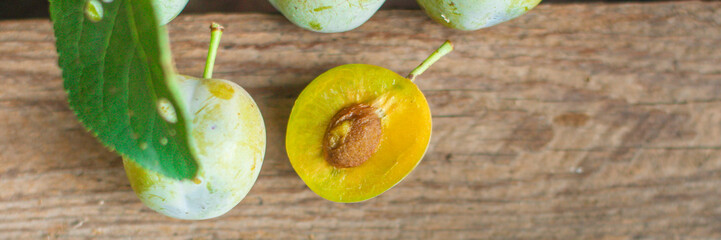 plum, fruit cut (white grade plums, yellow pulp). top view. food background