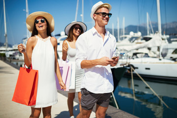 Vacation, travel, sea, friendship and people concept. Smiling friends having fun together