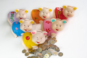 Six color piggy bank with coin pile six jar concept