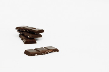 stack pieces of chocolate with nuts isolated on white
