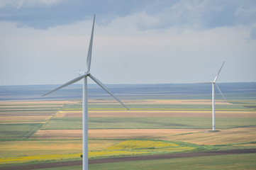 Wind turbines in a wind farm with a dramatic stormy sky in the background