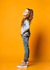 portrait of little beautiful stylish kid girl in jeans