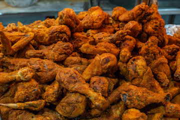 Huge pile of tasty chicken drumsticks fried with batter