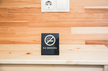 No smoking sign on the bedside table. Hotel things.