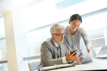 Corporate business coleagues working together in modern office