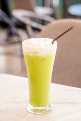Iced Green milk tea in the glass with straw