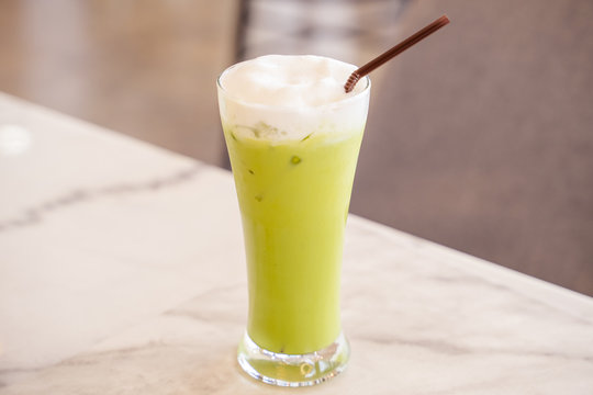 Iced Green milk tea in the glass with straw