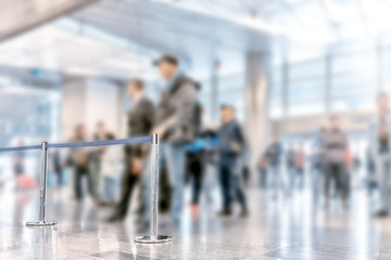 Obraz premium airport interior of modern terminal building arriving exit passage blur background wide inside view of business air travel trip blurred design concept with people waiting for passengers in sunny hall