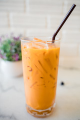 Thai milk tea in the glass with straw