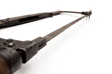 Old rusty hacksaw, isolated on white background.