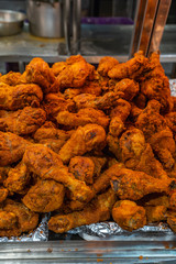 Yummy fried chicken drumsticks with batter at food stand