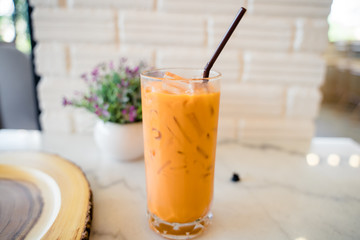 Thai milk tea in the glass with straw