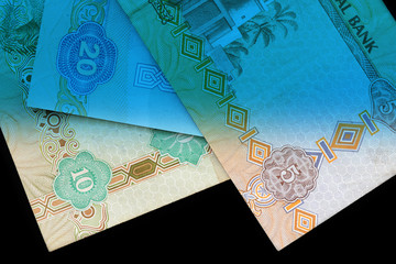 UAE dirham currency notes close up. Money background blue color toned