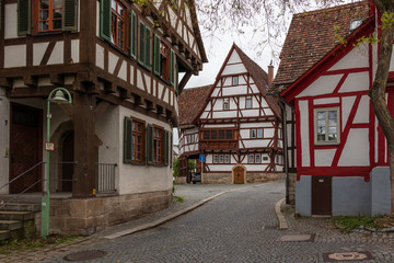 Fototapeta na wymiar Sindelfingen, Baden Wurttemberg/Germany - May 11, 2019: Street Scenario of Central District Road, Hintere Gasse with traditional house facades.