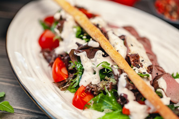 bread sticks with a salad of veggies and sauce