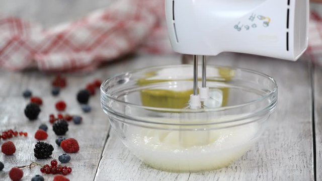 Keep whisking egg whites, gradually adding caster sugar. Making Meringue Cake