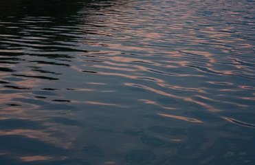 Water of the Preaek Tuek Chhu River near Kampot in Cambodia reflecting sunset