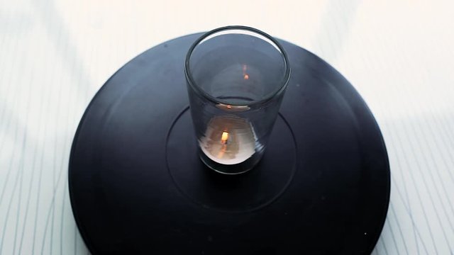 Candle in jar rotating on black background