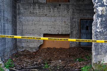 A yellow tape warns of the danger of asbestos dust