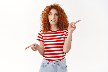 Attractive redhead girl picking new furniture asking opinion look camera questioned relaxed pointing left right sideways make choice deciding showing variety product, copy space, white background