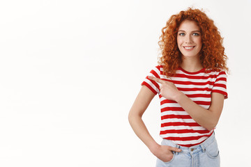 Upbeat good-looking gorgeous redhead curly woman striped t-shirt smiling white teeth pointing upper left corner index fingers help out friend find store show confidence recommend promo