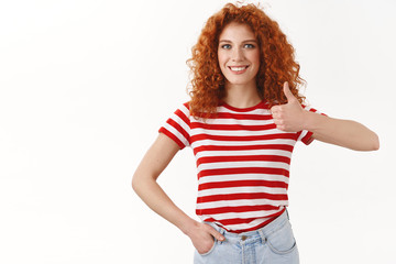 Sound interesting count me in. Cheerful gorgeous redhead curly woman give thumb up like awesome...