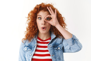 Amusement, surprise emotions concept. Amazed attractive redhead curly-haired blue-eyed female...