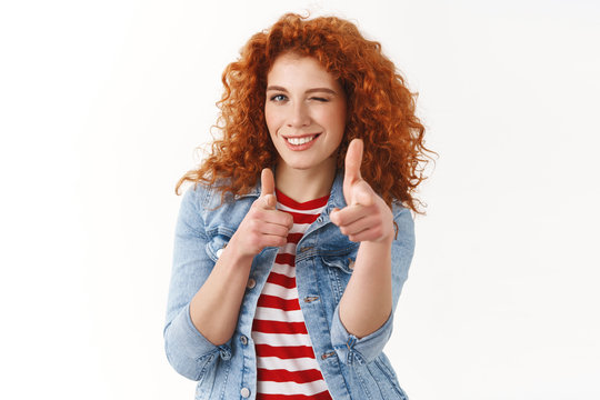 Waist-up Cheeky Good-looking Redhead Female Giving Hint Winking Playfully Pointing Finger Pistols Sassy Camera Inviting Friend Come Dance Together Standing White Background Upbeat